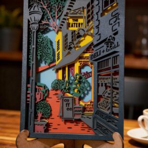 Dekorativna slojevita slika gradske ulice sa coffee shop motivom i urbanim detaljima u toplim cozy tonovima.